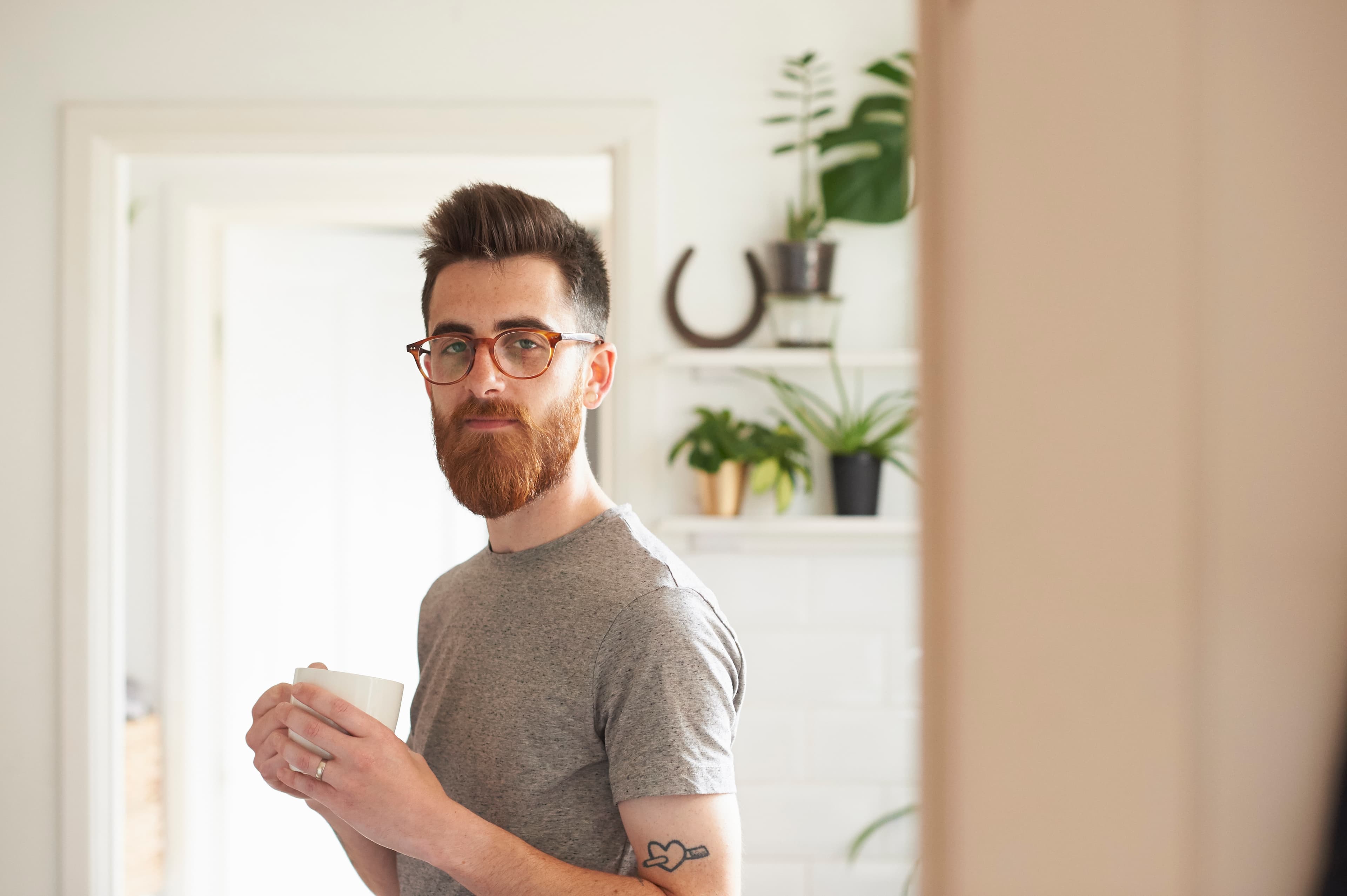 Man with glasses in a black-and-white portrait